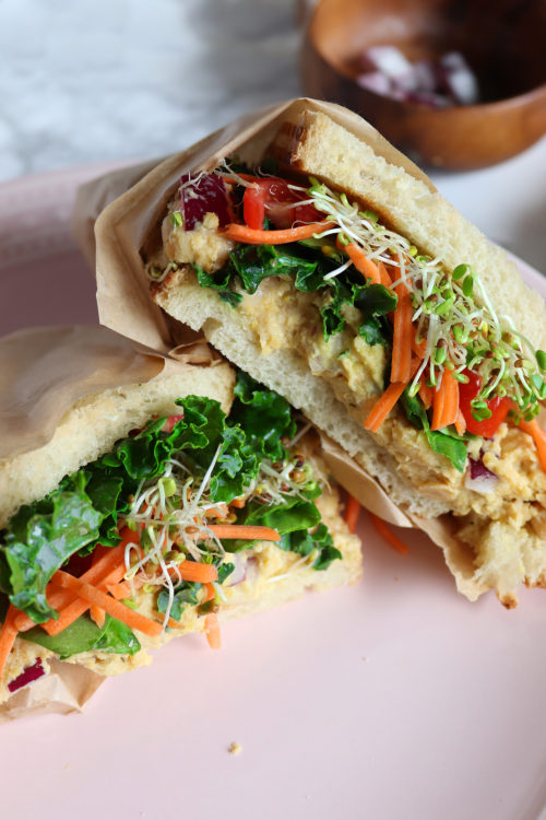 Chickpea Salad Sandwich with tomatoes, kale, sprouts, and carrots by Naturally Tessa